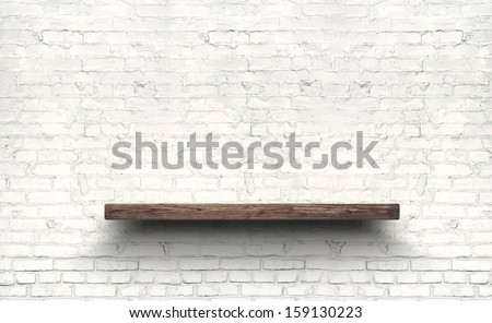Wood shelf on brick wall texture background.