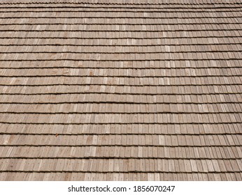 Wood shingles fixed with wooden nails on an old wooden roof