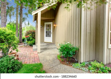 Wood Siding House With Small Entrance Porch. View Of White French Door And Walkway