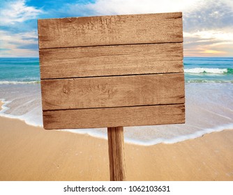 Wood Sign On Beach Background