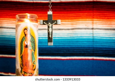 Wood And Silver Crucifix With Virgin Mary Prayer Candle To The Left, With Mexican Blanket As Backdrop. Cathoilc, Easter, Religion Concepts.