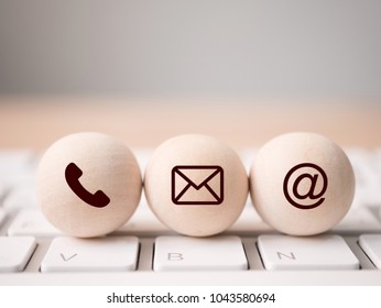 Wood sphere symbol telephone, mail, address and mobile phone. Website page contact us or e-mail marketing concept
