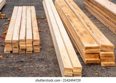 Wood Is Stacked In A Driveway, Having Just Been Delivered For The Start Of A New Home Addition Project