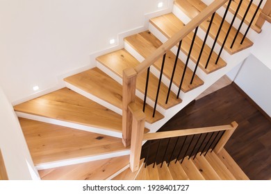 Wood staircase inside contemporary white modern house 