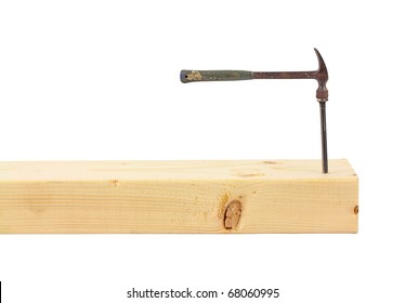 A Wood Stud With A Large Nail And A Small Hammer.