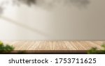 wood table background with sunlight window create leaf shadow on wall with blur indoor green plant foreground.panoramic banner mockup for display of product,warm tone lights