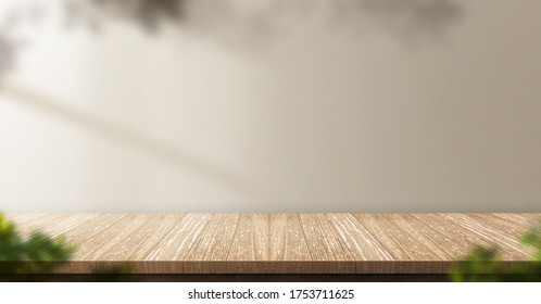 Wood Table Background With Sunlight Window Create Leaf Shadow On Wall With Blur Indoor Green Plant Foreground.panoramic Banner Mockup For Display Of Product,warm Tone Lights