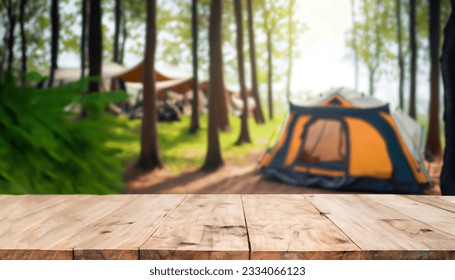 Wood table and Blurred camping and tents in forest. - Powered by Shutterstock