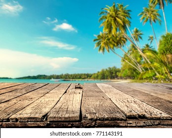 Wood Table With Blurred Sea And Coconut Tree Background