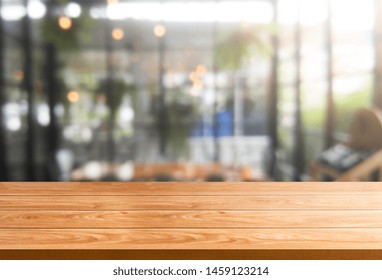 Wood Table In Blurry Background Of Modern Restaurant Room Or Coffee Shop With Empty Copy Space On The Table For Product Display Mockup. Interior Restaurant Counter Design Concept.