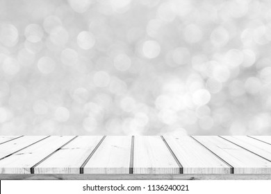 Wood table or wood floor with abstract white bokeh background for product display 