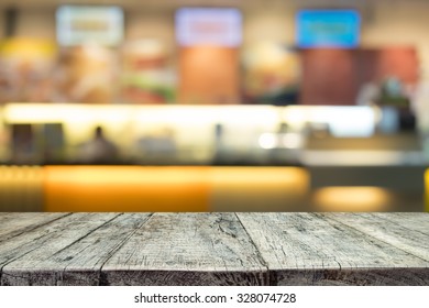 Wood Table Or Wood Floor On Blur Counter Bar Of Coffee Cafe Or Nightclub Background