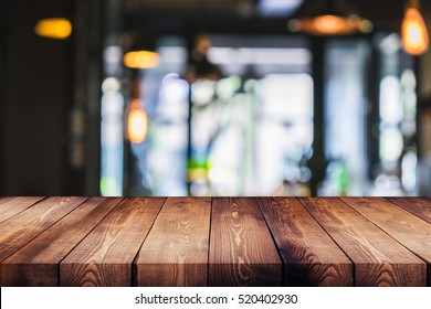 wood table on blur of cafe, coffee shop, bar, background - can used for display or montage your products - Shutterstock ID 520402930