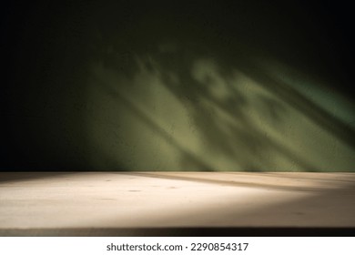 Wood table on dark green texture wall background. Composition with leaves shadow on the wall and light reflections. Mock up for presentation, branding products, cosmetics food or jewelry. - Shutterstock ID 2290854317