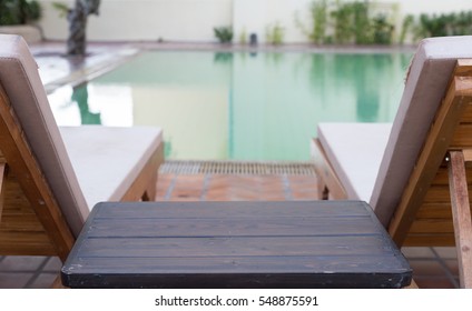 Wood Table And Pool Chair For Resting And Relaxing At Poolside Of Swimming Pool
