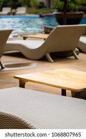 Wood table and sofa at swimming pool.