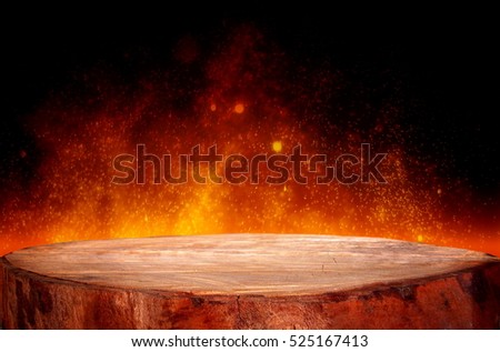 Wood table or stump on flame with bokeh background. 