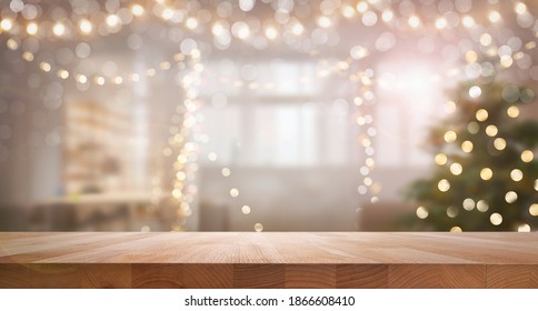 A wood table, tabletop product display with a festive Christmas background of Christmas tree and fairy lights. - Powered by Shutterstock