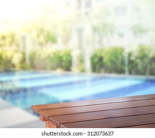 Wood Table Top Of Background And Pool