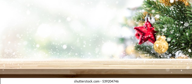 Wood Table Top Banner Background With Snow And Ornaments On Christmas Tree