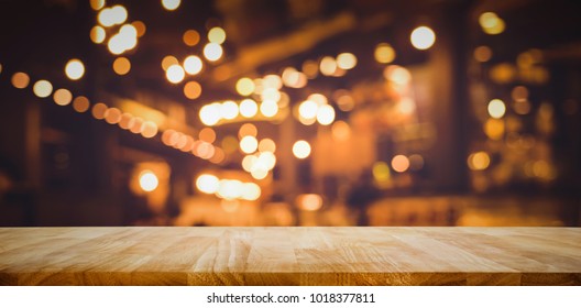 Wood Table Top (Bar) With Blur Light Bokeh In Dark Night Cafe,restaurant Background .Lifestyle And Celebration Concepts Ideas