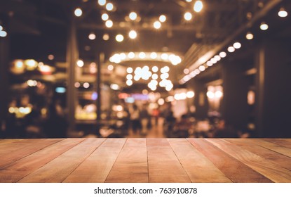 Wood table top (Bar) with blur light bokeh in dark night cafe,restaurant background .Lifestyle and celebration concepts ideas - Shutterstock ID 763910878