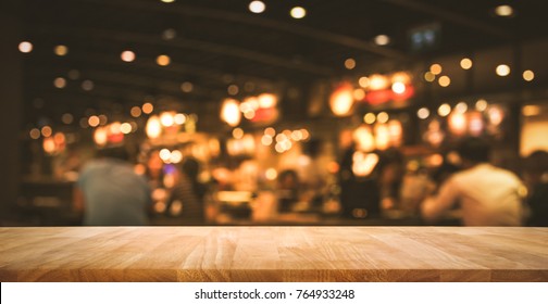 Wood Table Top (Bar) With Blur Light Bokeh In Dark Night Cafe,restaurant Background .Lifestyle And Celebration Concepts Ideas