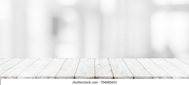 Wood table top and blurred abstract background from interior building banner background - can used for display or montage your products. - Shutterstock ID 704683651