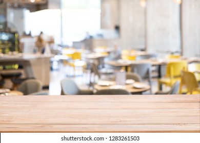Wood Table Top With Defocused Background Of Restaurant, Bar Or Cafeteria Background For Your Product Display.