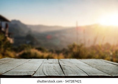 Wood Table Top In Front Of Of Trees In The Forest. Blur Background Image, For Product Display Montage.
