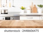 Wood table top on blur kitchen room counter background for product display