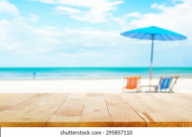 Wood Table Top On Blur Beach Background With Beach Chairs And Parasol - Can Be Used For Display Or Montage Your Products