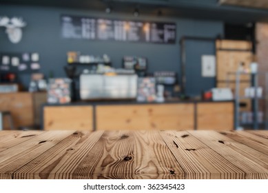 Wood Table Top On Blur Coffee Shop Background