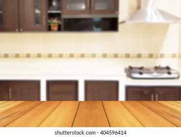 Wood table top on blur the background of the kitchen. - can be used for display your products or promotional and advertising posters - Shutterstock ID 404596414
