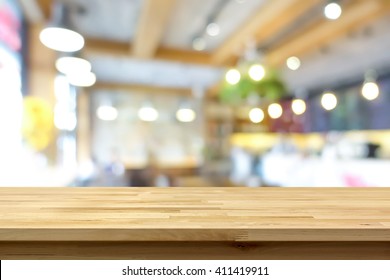 Wood Table Top On Blur Background Of Coffee Shop (or Restaurant) Interior - Can Be Used For Display Or Montage Your Products