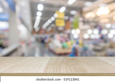 Wood table top on blur with bokeh shopping mall background - can be used for display or montage your products