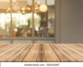 Wood Table Top On Blur Kitchen In Home Background. Perspective Brown Wooden Table Over Blur In Kitchen Loft Background - Can Be Used Mock Up For Montage Products Display Or Design Key Visual Layout.