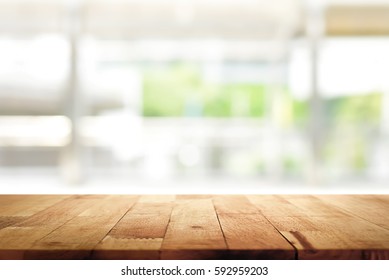 Wood table top on blur kitchen window background - can be used for display or montage your products (foods) - Shutterstock ID 592959203