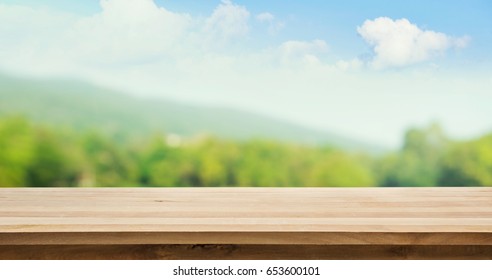Wood Table Top On Blur Tree And Mountain Background .summer,nature Concepts