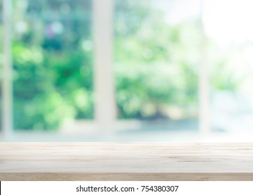 Wood Table Top On Blur Of Window With Garden Flower Background In Morning.For Montage Product Display Or Design Key Visual Layout