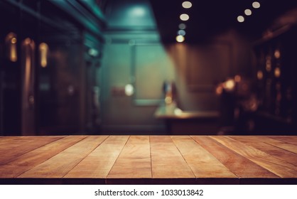 Wood Table Top On Blurred Of Counter Cafe Shop With Light Bulb Background.for Montage Product Display Or Design Key Visual Layout.