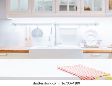 Wood table top on blurred kitchen background - Shutterstock ID 1673074180