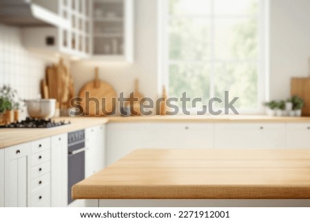 Wood table top on blurred kitchen background.  can be used mock up for montage products display or design layout	