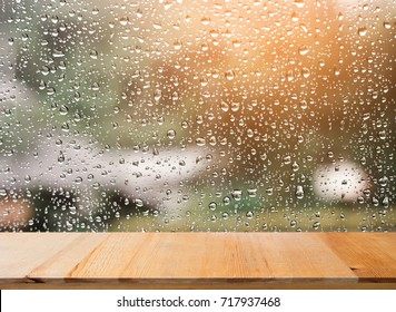 Wood table top on rain drops on clear window - can be used for display or montage your products - Shutterstock ID 717937468