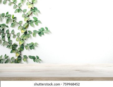 Wood Table Top On White Wall With Leaf Background.For Montage Product Display Or Design Key Visual Layout