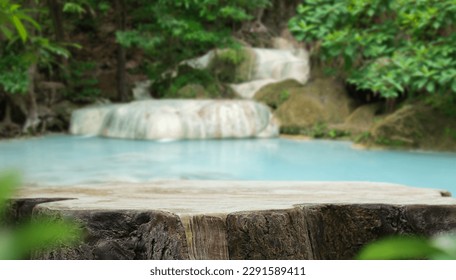 Wood table top podium floor in outdoor waterfall green tropical forest nature background.Natural water product present placement pedestal counter display, spring summer jungle paradise concept. - Powered by Shutterstock