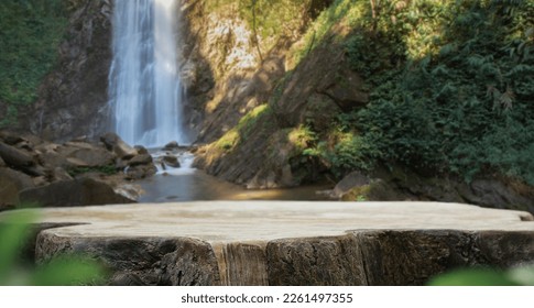 wood table top podium in outdoors waterfall green lush tropical forest nature background.organic healthy natural product present placement pedestal counter display,website banner cover jungle concept.