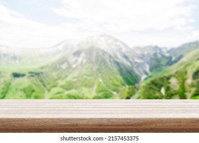 
Wood Table Top Stand With Blur Mountain Landscape View Background In Spring. Food Product Display With Nature Concept Backdrop. 