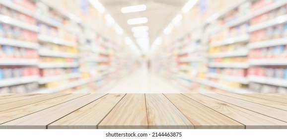 Wood Table Top With Supermarket Grocery Store Aisle Interior Blurred Background With Bokeh Light For Product Display