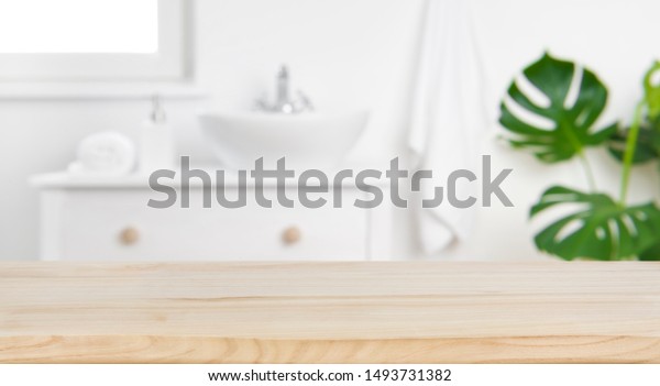 Wood tabletop on blur bathroom background, design\
key visual layout